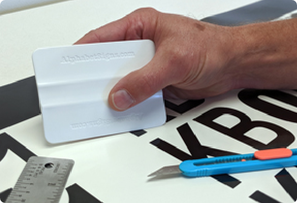 applying a vinyl decal with a squeegee