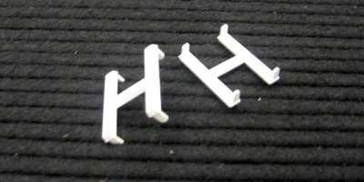 two letter h on felt board showing pins