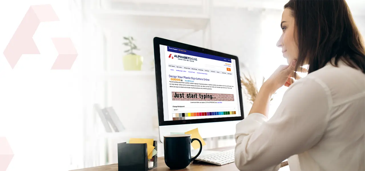 design your signage online woman sitting at computer screen