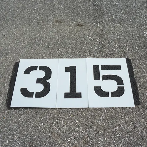 plastic cut out stencil on pavement of number 315