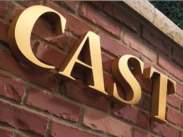cast metal sign letter on wall